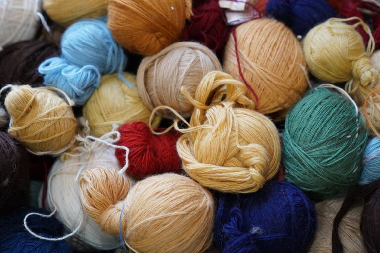A diverse assortment of colorful yarn balls, perfect for knitting and crafting projects.
